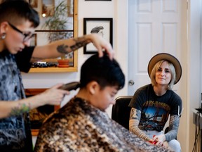 Two Horses salon owner Izzy Mulder watches as a client gets a hair cut. All money earned at the salon Dec. 12, 2016, was donated to Project 10, a Montreal organization that works to promote the personal, social, sexual and mental well being of lesbian, gay, bisexual, transgender, transsexual, two-spirit, intersexed and questioning youth and adults 14-25.