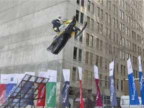 A stunt performer puts on a demonstration in downtown Montreal  to promote a snowmobiling event to be held Feb. 4-5 as part of the city's 375th anniversary celebrations.
