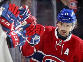 Montreal Canadiens players reach out to congratulate Tomas Plekanec after his goal during second period of National Hockey League game in Montreal Tuesday December 20, 2016.