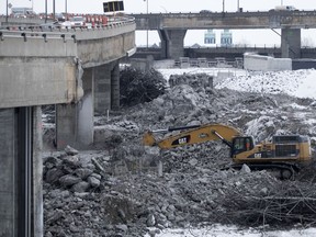A mechanical shovel is used to demolish a section of the Turcot Interchange in December 2016.