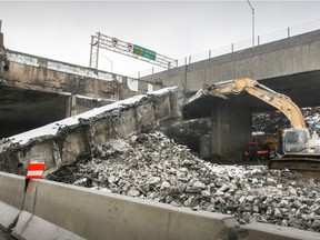 Excavators work to take down sections of the eastbound Ville-Marie expressway in Montreal.