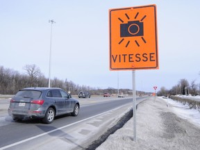 Temporary road sign which indicates photo radar cameras at the construction zone on the 40 eastbound towards the Island of Montreal at the Chateau Vaudreuil in Vaudreuil.