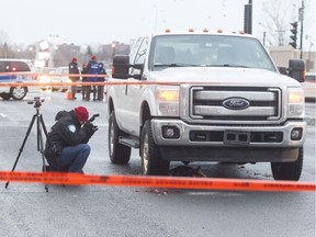 Montreal police examine a pickup truck that fatally struck a pedestrian on Decarie Boulevard, just north of Jean Talon, in Montreal, Wednesday January 11, 2017.  The cause of the accident is being investigated.