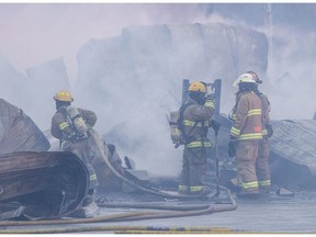 Firefighters battle a blaze at a shopping complex on Route 138 in Kahnawake, south of Montreal, Thursday January 12, 2017.  The cause of the fire is being investigated.