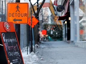 A sign is meant to let people know Ferrari Restaurant remains open during construction on Bishop St. in Montreal in January 2016.