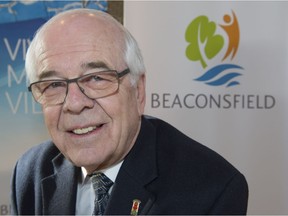 Beaconsfield Mayor Georges Bourelle is all smiles as he is shown with the new logo the Montreal suburb has adopted on Monday, January 16, 2017.