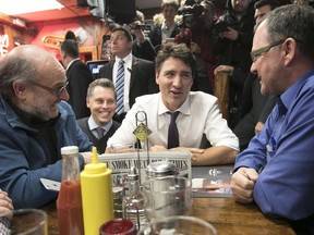 Prime Minister Justin Trudeau sits down with restaurant patrons in Montreal.