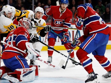 Montreal Canadiens goalie Carey Price follows the pucks as it bounces off of him during NHL action at the Bell Centre in Montreal on Wednesday January 18, 2017. Montreal Canadiens defenceman Zach Redmond  clears the puck as Montreal Canadiens defenceman Nathan Beaulieu, centre, Pittsburgh Penguins centre Eric Fehr, left, and Pittsburgh Penguins left wing Chris Kunitz look on.