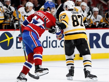 Pittsburgh Penguins centre Sidney Crosby hangs on to and spins Montreal Canadiens left wing Max Pacioretty around in circles during NHL action at the Bell Centre in Montreal on Wednesday January 18, 2017.