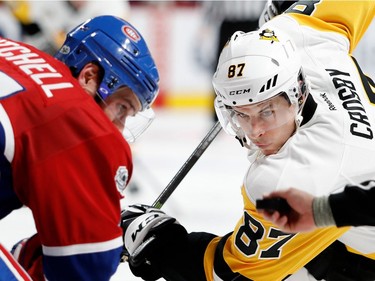 Pittsburgh Penguins centre Sidney Crosby and Montreal Canadiens centre Torrey Mitchell wait for the puck to drop during NHL action at the Bell Centre in Montreal on Wednesday January 18, 2017.