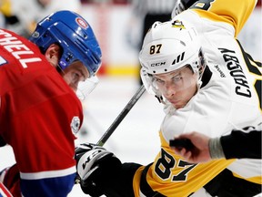 Pittsburgh Penguins centre Sidney Crosby and Montreal Canadiens counterpart Torrey Mitchell wait for the puck to drop during NHL action at the Bell Centre in Montreal on Wednesday January 18, 2017.