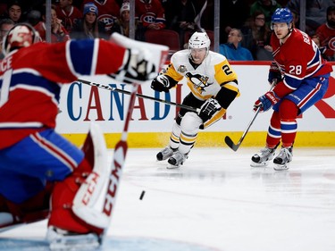 Pittsburgh Penguins defenceman Chad Ruhwedel (2) and Montreal Canadiens defenceman Nathan Beaulieu watch as Montreal Canadiens goalie Carey Price stops Ruhwedel's shot during NHL action at the Bell Centre in Montreal on Wednesday January 18, 2017.