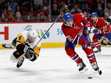 Pittsburgh Penguins defenceman Justin Schultz gets sent to the ice as he duels with Montreal Canadiens centre Andrew Shaw during NHL action at the Bell Centre in Montreal on Wednesday January 18, 2017.