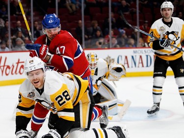 Pittsburgh Penguins defenceman Ian Cole grimaces as he is knocked to the ice by Montreal Canadiens right wing Alexander Radulov during NHL action at the Bell Centre in Montreal on Wednesday January 18, 2017. Pittsburgh Penguins goalie Matt Murray and Pittsburgh Penguins defenceman Justin Schultz, right, look on.