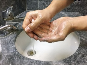 A man washes his hands at an office in Montreal Friday January 20, 2017.  Hand washing is one of the recommended measures to take to try to prevent common viruses, like norovirus.