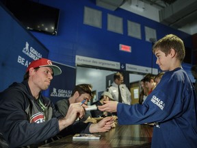 Ten year-old Gabriel Gravel hands off a note to Montreal Canadiens defenceman Shea Weber as children line up for autographs during an event where the National Hockey League Players' Association donated 25 complete sets of new hockey equipment to the Deux-Montagnes police force hockey program at the Bell Sports Complex in Brossard on Monday, January 23, 2017.