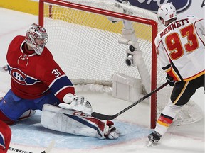 Flames' Sam Bennett puts puck past Canadiens goalie Carey Price in the dying seconds of the third period at the Bell Centre Tuesday night.