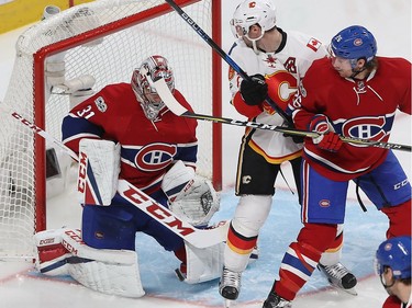 Montreal Canadiens goalie Carey Price stop puck on Calgary Flames' Troy Brouwer checked by Montreal Canadiens' Jeff Petry (26) during second period NHL action in Montreal on Tuesday January 24, 2017.