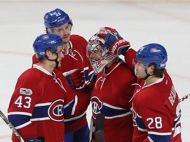 Montreal Canadiens goalie Carey Price, centre, following win over the Calgary Flames with teammates Daniel Carr (43), Jeff Petry (26) and Nathan Beaulieu (28) in Montreal on Tuesday January 24, 2017.