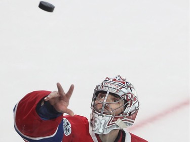 Montreal Canadiens goalie Carey Price throws puck in the crowd following his first star selection after the Montreal Canadiens won over the Calgary Flames in NHL action in Montreal on Tuesday January 24, 2017.
