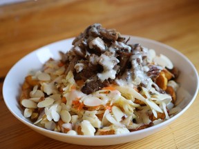 Le P’tit Creux du Plateau's contribution to the fifth edition of La Poutine Week features plantain, griot (pork), tarragon sauce and pikliz, a spicy coleslaw.