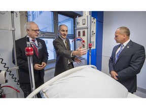 Carlos J. Leitao left, Member for Robert-Baldwin, Quebec Liberal Party Minister of Finance gets a rundown of the new intensive care units at the Lakeshore General Hospital in Pointe Claire from ICU chief, Dr. Robert Salasidis right, as David Cescon Co-Chair of the LGH foundation looks on.
