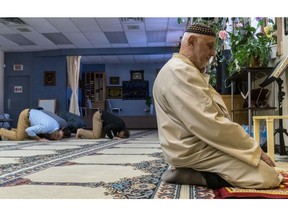 MONTREAL, QUE.: JANUARY 30, 2017 -- Mehmet Deger, right, President of the Dorval Mosque praying on Monday, January 30, 2017.  The Dorval mosque has been vandalized 9 times in the past. (Dave Sidaway / MONTREAL GAZETTE) ORG XMIT: 58040