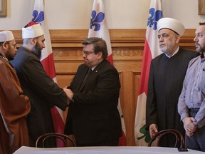 Montreal Mayor Denis Coderre meets with leaders of the Muslim community at Montreal city hall on Monday.