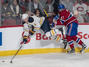 Buffalo Sabres defenceman Cody Franson, left, falls as he is pushed by Montreal Canadiens right wing Alexander Radulov, right, during the second period of their NHL hockey match in Montreal on Tuesday, Jan. 31, 2017.