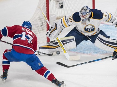 Buffalo Sabres goalie Robin Lehner makes a save against Montreal Canadiens centre Torrey Mitchell during the first period of their NHL hockey match in Montreal on Tuesday, Jan. 31, 2017.