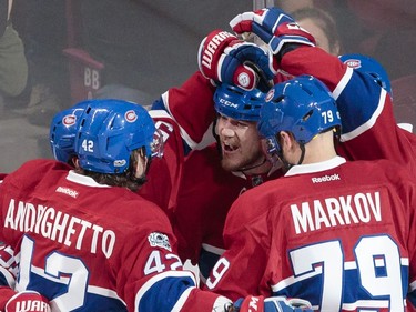 Montreal Canadiens centre David Desharnais, centre, is congratulated by teammates after scoring a goal against the Buffalo Sabres during the second period of their NHL hockey match in Montreal on Tuesday, Jan. 31, 2017.