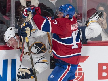 Montreal Canadiens centre Torrey Mitchell, front, collides with Buffalo Sabres centre Jack Eichel, rear, during the third period of their NHL hockey match in Montreal on Tuesday, Jan. 31, 2017.