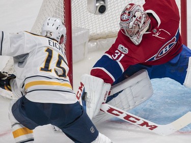 Montreal Canadiens goalie Carey Price, right, makes a save against Buffalo Sabres centre Jack Eichel, left, during the second period of their NHL hockey match in Montreal on Tuesday, Jan. 31, 2017.