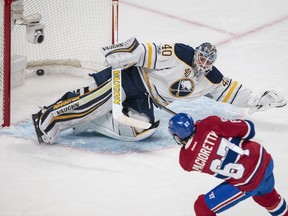 Montreal Canadiens left wing Max Pacioretty, bottom, scores a goal on Buffalo Sabres goalie Robin Lehner during the first period of their NHL hockey match in Montreal on Tuesday, Jan. 31, 2017.