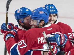 Montreal Canadiens left wing Max Pacioretty, centre, is congratulated by teammates Alexander Radulov, left, and Phillip Danault, right, after scoring his second goal against the Buffalo Sabres during the second period of their NHL hockey match in Montreal on Tuesday, Jan. 31, 2017.