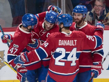 Montreal Canadiens left wing Max Pacioretty, second from left, is congratulated by teammates after scoring his third goal against the Buffalo Sabres during the third period of their NHL hockey match in Montreal on Tuesday, Jan. 31, 2017.