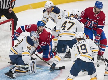 Montreal Canadiens left wing Max Pacioretty, right, battles for the puck against Buffalo Sabres defenceman Zach Bogosian, second from right, as Montreal Canadiens left wing Phillip Danault, second from left, collides with Buffalo Sabres goalie Robin Lehner, left, during the third period of their NHL hockey match in Montreal on Tuesday, Jan. 31, 2017.