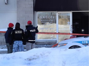 Laval police officers stand in front of Streakz Coiffure, owned by Polisena Delle Donne, the wife of Guiseppe Torre, 45. The hair salon was firebombed this morning in Laval on January 5, 2107.  (Marie-France Coallier / MONTREAL GAZETTE)