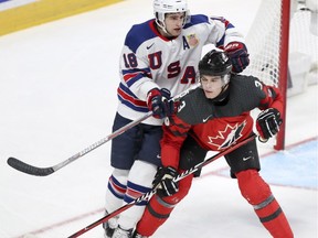 Team Canada defenceman and Montreal Canadiens prospect Noah Juulsen battles with USA's Colin White during the second period of the gold medal game at the World Junior Hockey Championship in Montreal Thursday January 5, 2017.