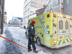 An ambulance with police officers inside leaves the scene of a police shooting of a suspect near the Old Brewery Mission in Montreal on Friday, Jan. 6, 2017.