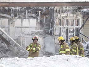 Laval firefighters survey the scene of a fire that destroyed several businesses at René-Laennec Blvd. and Lausanne St. in Laval, north of Montreal, Monday January 9, 2017.  There were no injuries and police suspect arson.