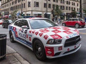 Montreal police cars are plastered with stickers to protest against pension changes.