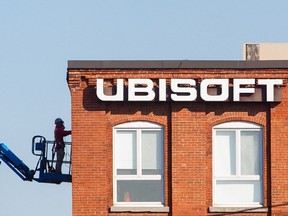 MONTREAL, QUE.: NOVEMBER 3, 2015 -- 11:41am -- A construction worker fixes brickwork beside the logo of the video game studio Ubisoft outside the company's headquarters at 5505 St-Laurent boulevard, at the intersection of St-Viateur ave, in Montreal on Tuesday, November 3, 2015. (Dario Ayala / Montreal Gazette)
