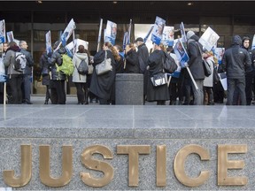 Quebec Lawyers and notaries march at the Montreal courthouse Oct. 24, 2016, as part of the first day of a general strike.