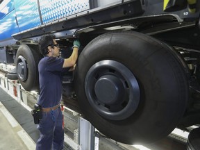 Mechanic Fernelly Zuniga adjusts a brake system on a new métro Azure car at Ateliers Youville, the first and largest maintenance centre for métros in Montreal. The Montreal métro system has been in operation 50 years.