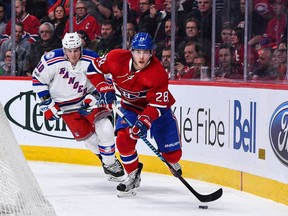 Nathan Beaulieu of the Montreal Canadiens skates the puck past J.T. Miller of the New York Rangers during the NHL game at the Bell Centre on January 14, 2017 in Montreal, Quebec, Canada.