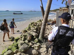 Police guard the exit of the Blue Parrot nightclub in Playa del Carmen, Mexico, Monday, Jan. 16, 2017. A deadly shooting occurred in the early morning hours outside the nightclub while it was hosting part of the BPM electronic music festival, according to police.