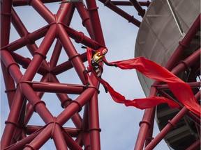 An acrobat abseils from the ArcelorMittal Orbit tower in London, England, in 2014.