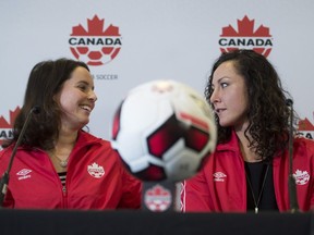 Rhian Wilkinson, left, and Melissa Tancredi of Canada's women's soccer team attend a news conference in Vancouver on Friday, Jan. 13, 2017, to announce their retirement from the team.