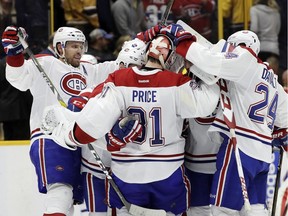 Canadiens defenseman Shea Weber, left, and winger Phillip Danault (24) celebrate with goalie Carey Price after the Canadiens beat the Nashville Predators 2-1 in overtime Tuesday, Jan. 3, 2017, in Nashville.